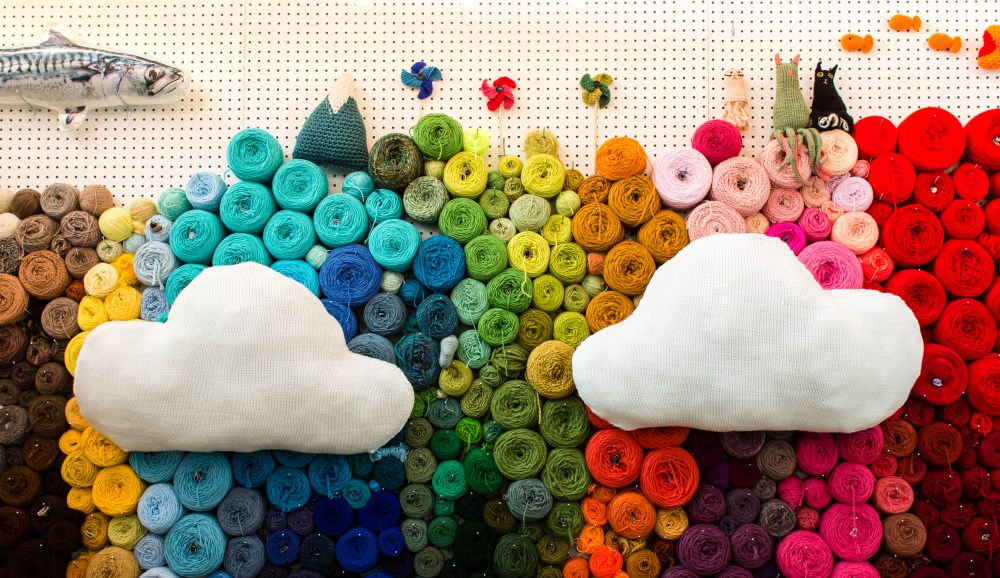 Machine knit clouds on a wall of yarn