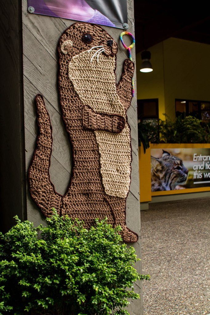 Curiodyssey x Knits for Life Bubbles & Rainbows Otter Yarnbomb