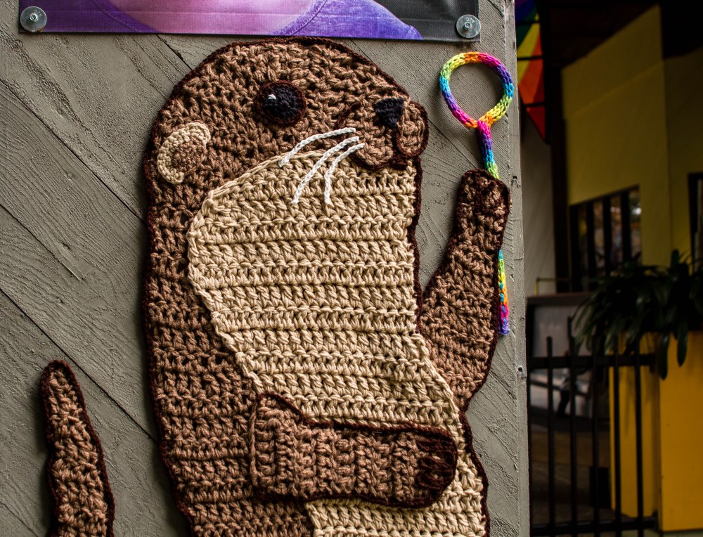 Curiodyssey x Knits for Life Bubbles & Rainbows Otter Yarnbomb